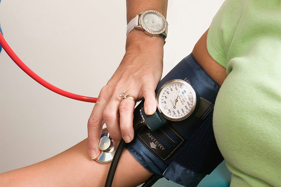 Nursing taking patient's blood pressure