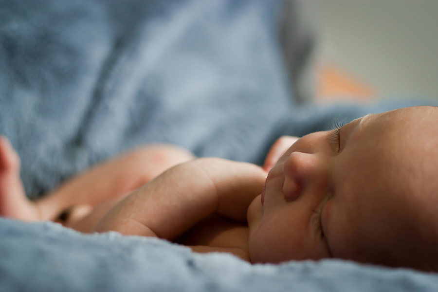 An infant lying in bed