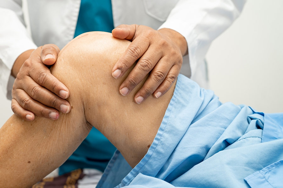 A patient getting their knee examined