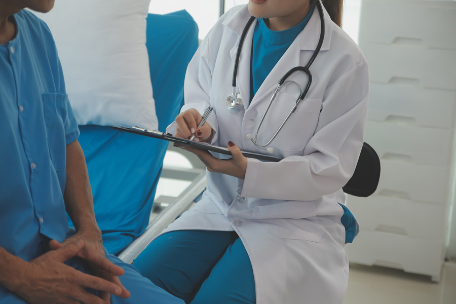 Healthcare provider writing on a clipboard