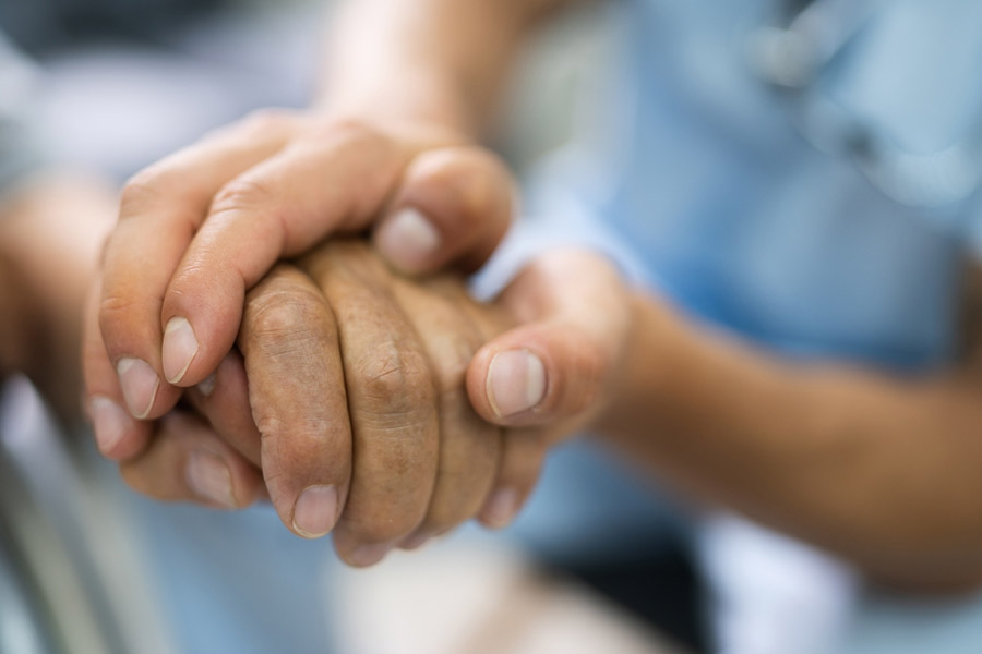 Two individuals holding hands