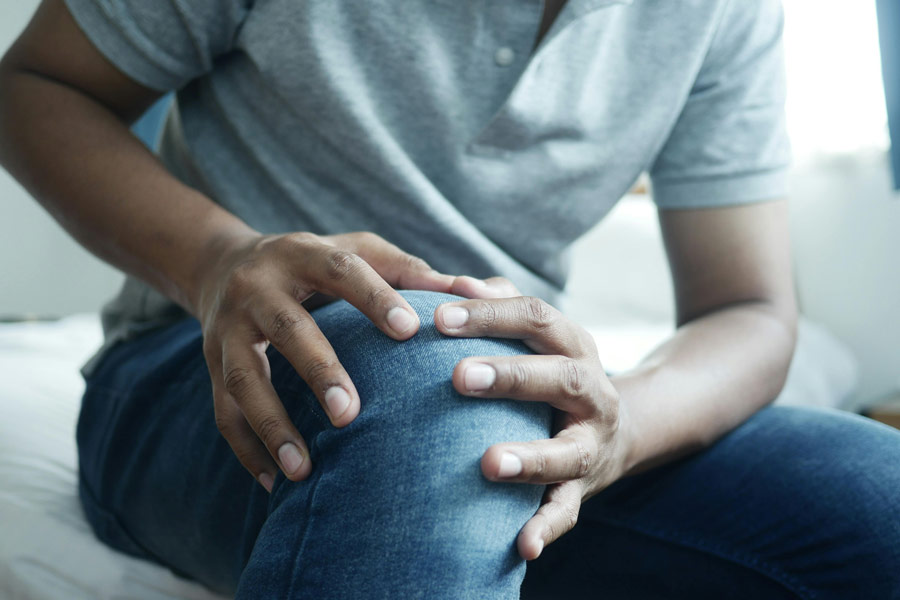 Man holding knee with pain